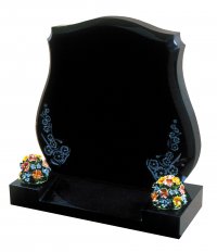 A Black granite memorial with a floral design.