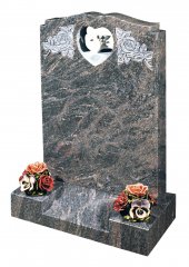 A traditionally shaped Himalayan Blue granite memorial, with a marble dove.