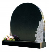 A circular Black granite memorial with hand carved tulips.